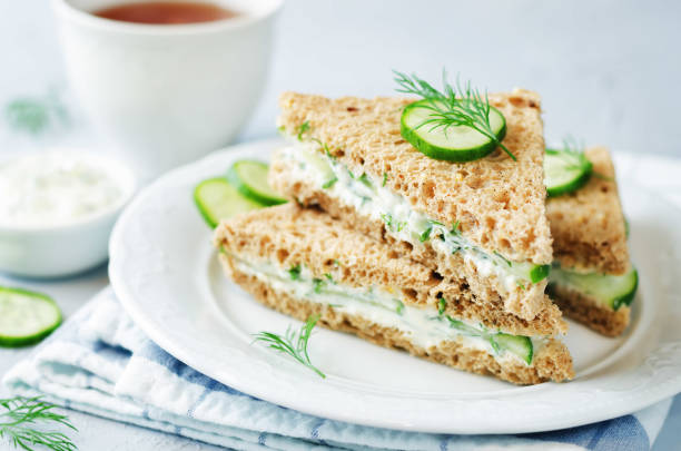 Cream cheese dill cucumber english tea sandwiches. toning. selective focus